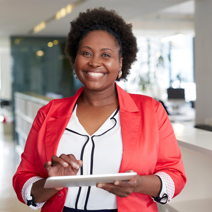 smiling woman holding ipad
