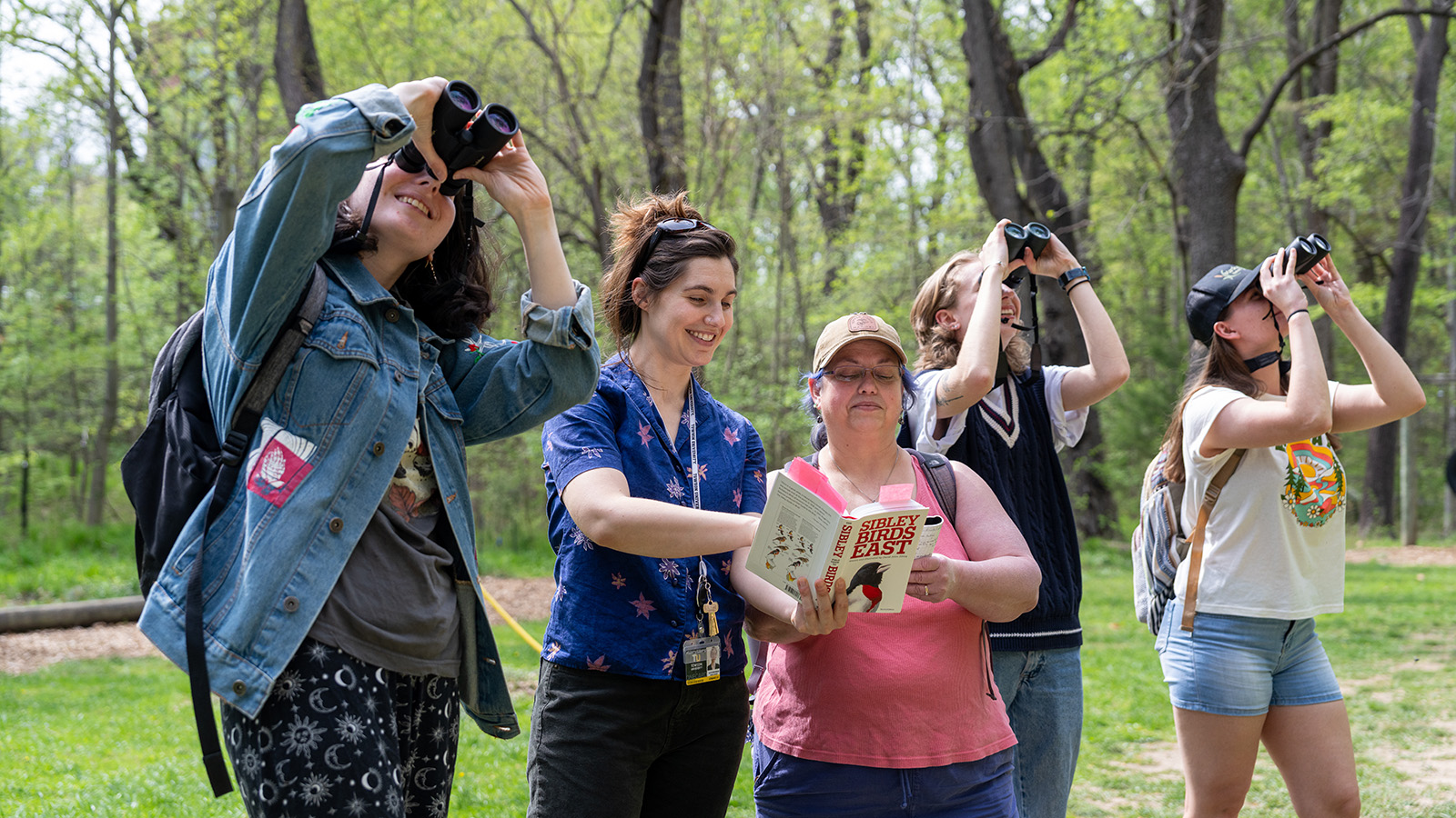 Students and professor looking at birds