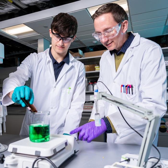 Sivey working with a student in his Aqueous Environmental Chemistry Laboratory 