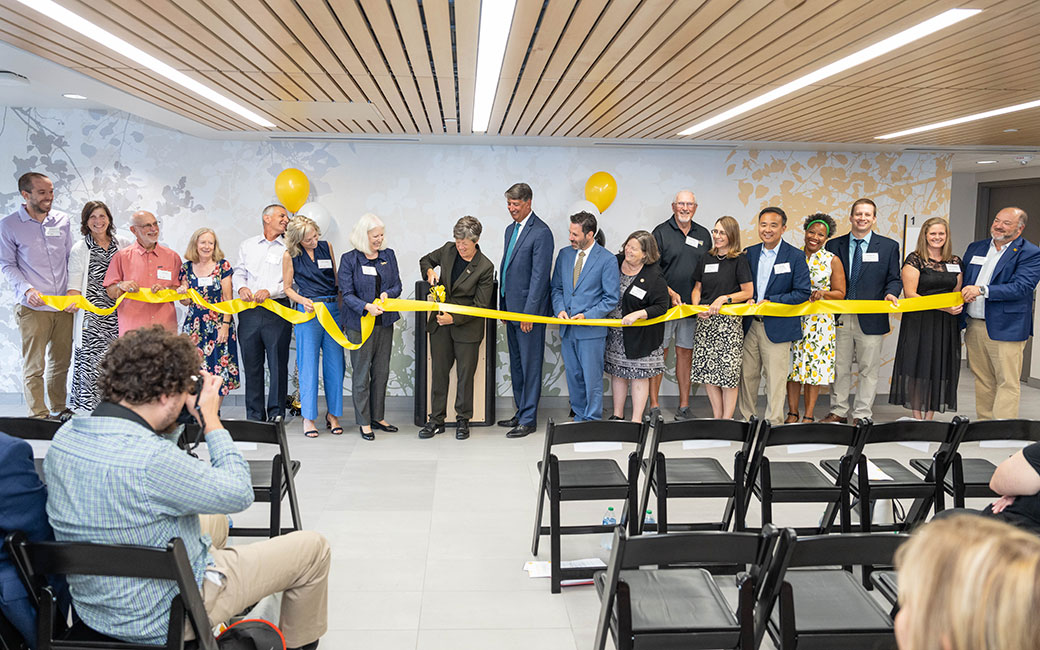 Institute for Well-Being Ribbon Cutting People gather to cut the ribbon.