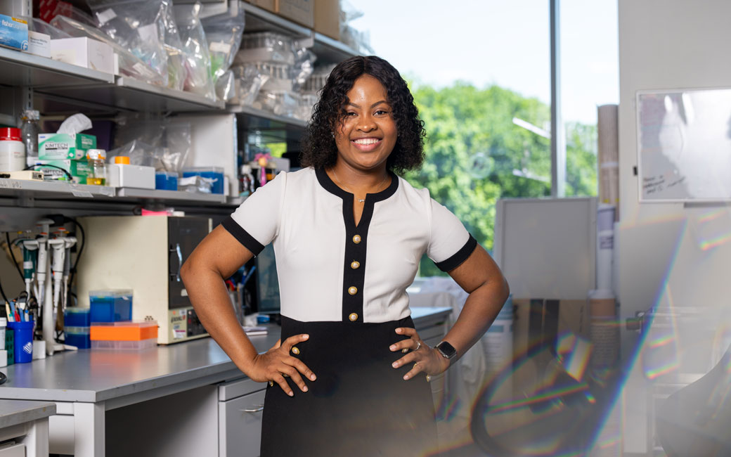 Woman student stands in lab in Science Complex