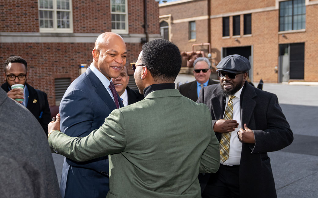 Two men shake hands
